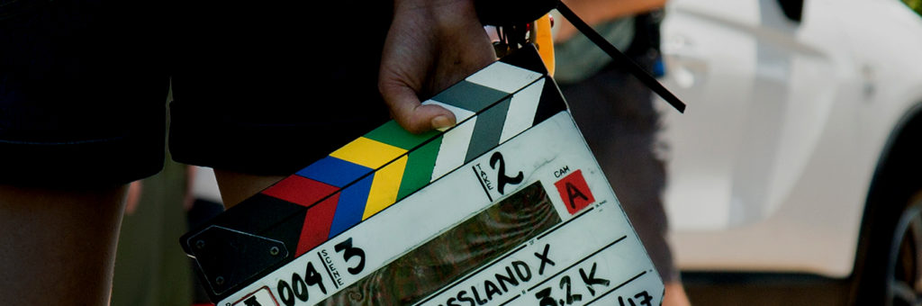 The Outfit - Who we are - On set clapper board
